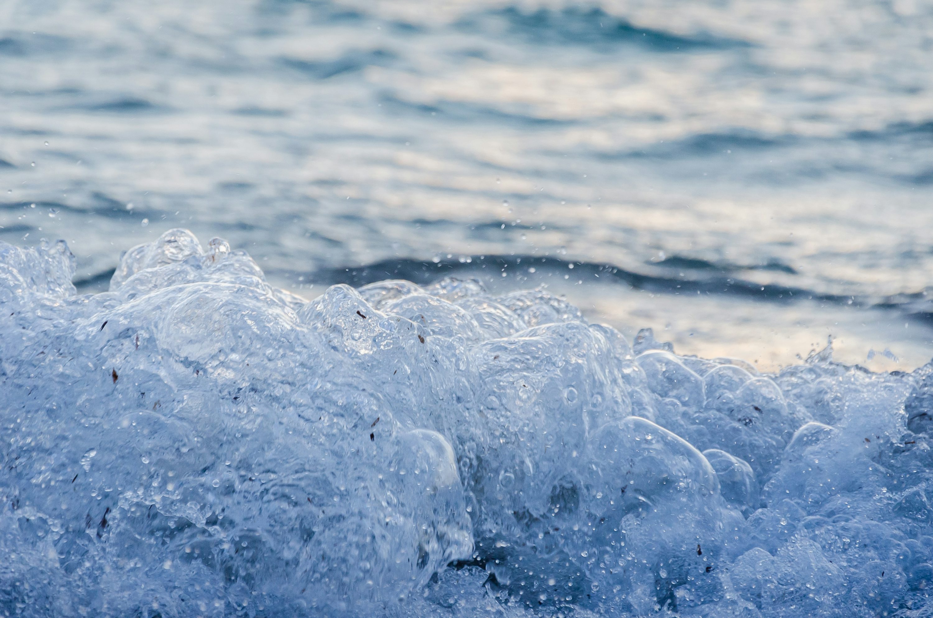 Ocean wave splash closeup showing crystal clear water
